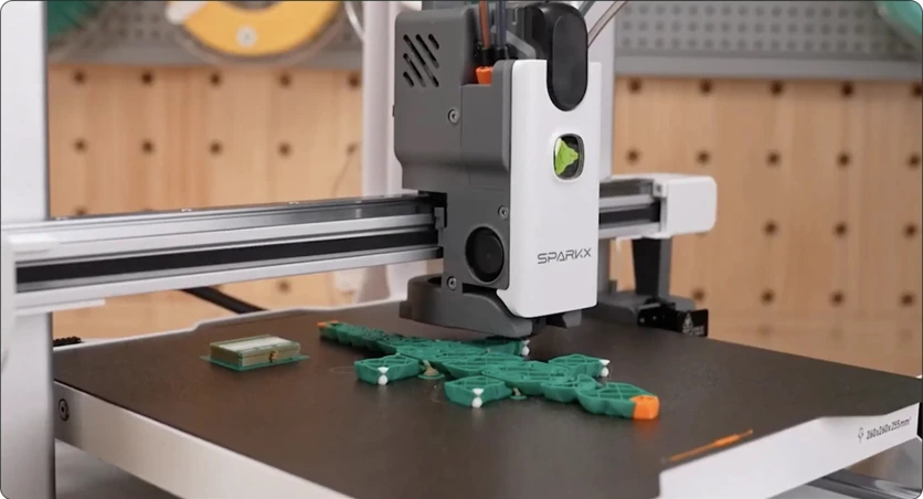 The SPARKX i8 part-way through a multicolor print in green, white and orange
